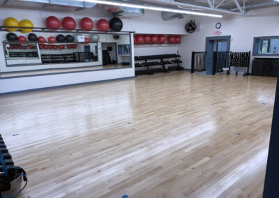 Group fitness room with free weights and bosu balls