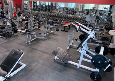 Weight room with 3 squat racks, hack squat, deadlift platform and more